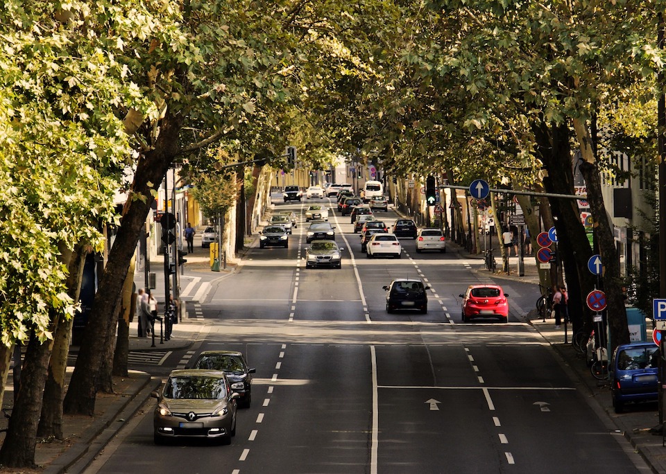 Subject cars driving on a tree lined European street to Research Professionals CRO clinical sites for a clinical trial.